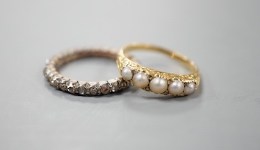 A 19th century yellow metal and rose diamond set full eternity ring, size L/M and an early 20th century yellow metal and graduated split pearl ring, size K/L, gross weight 5.8 grams.